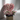Heart-shaped bouquet of pink and white roses on a stand against a light background