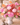 Colorful floral arrangement in a white vase on a wooden table.